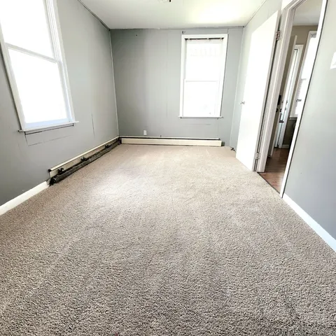 an empty room with a windows