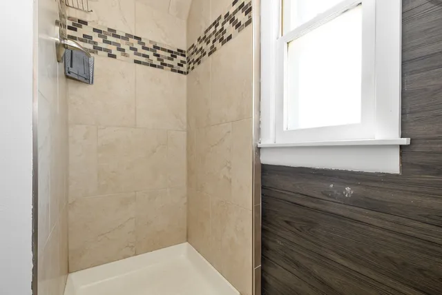 a bathroom with a shower and a sink