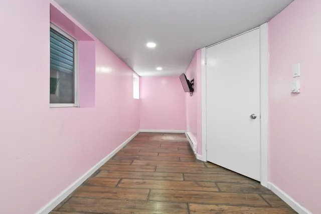a view of hallway with wooden floor