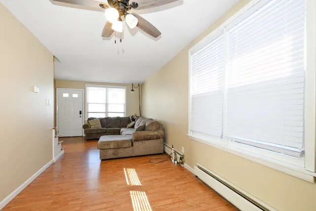 a living room with furniture and a chandelier