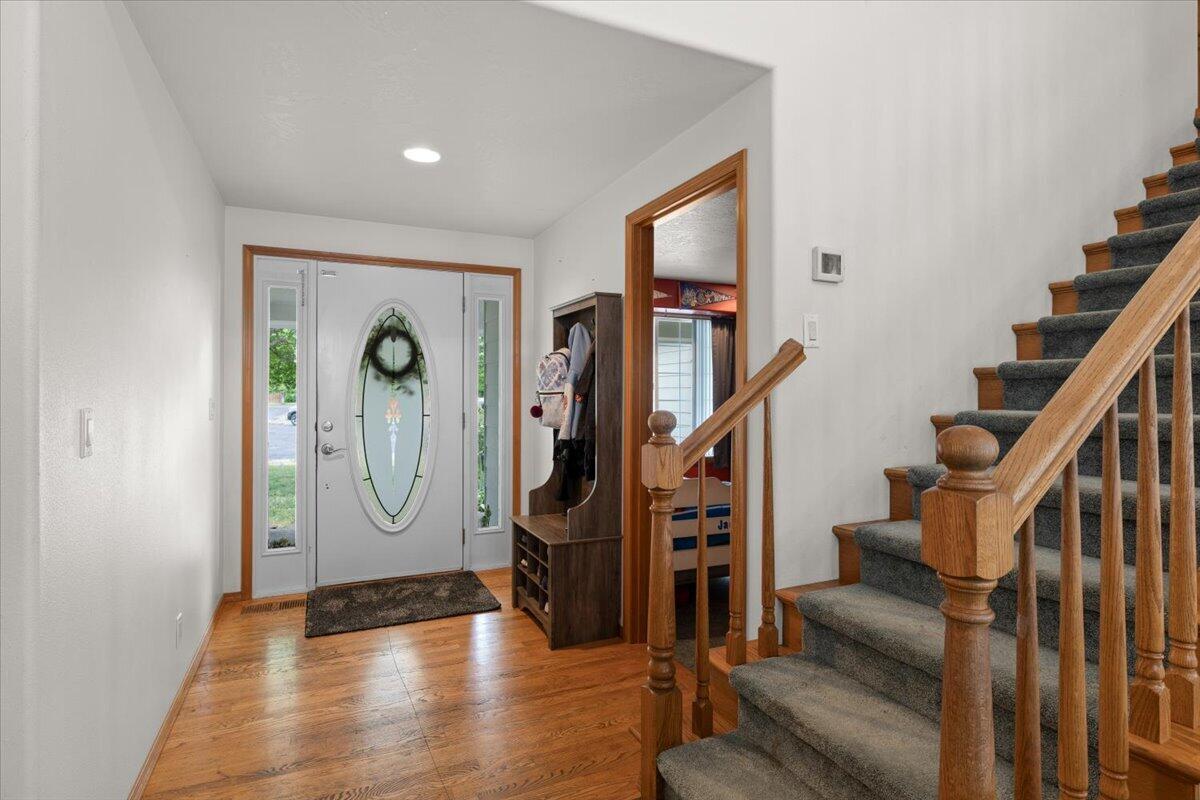 752 Mallory Court Central Point, OR 97502 - Photo 6 of 32 a view of an entryway with wooden floor and front door