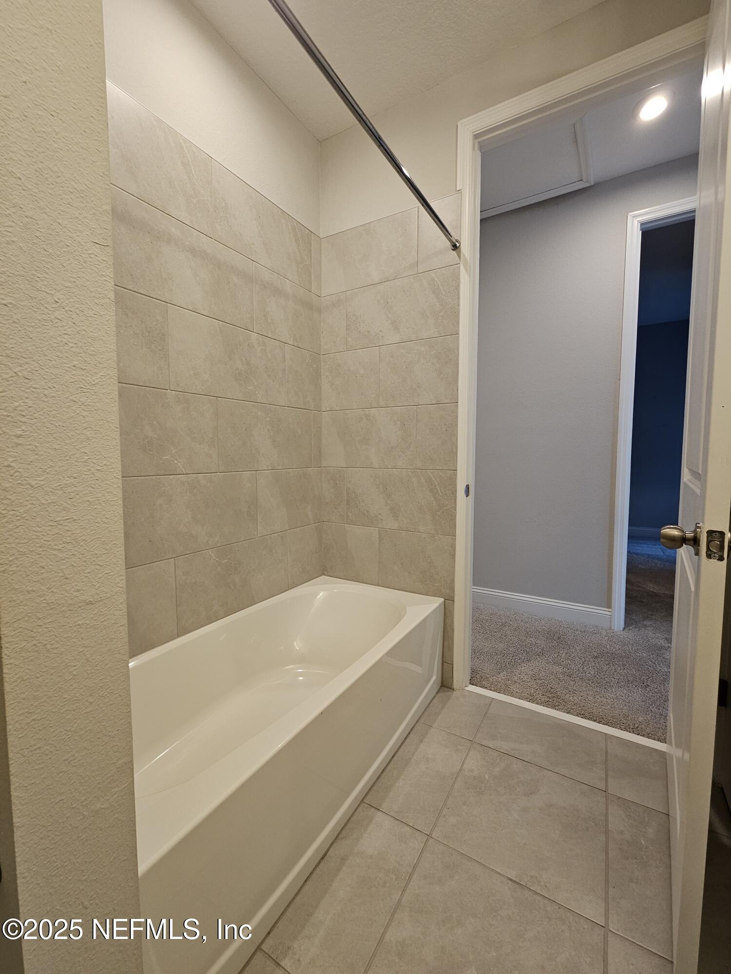 3434 Marsh Reserve Boulevard Jacksonville, FL 32224 - Photo 34 of 39 a bathroom with a bathtub and a shower