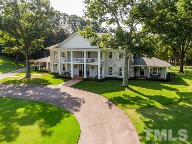 a front view of a house with a yard table and chairs