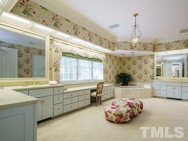 4613 Stormy Gale Road Raleigh, NC 27614 - Photo 17 of 30 a bathroom with a tub sink and mirror