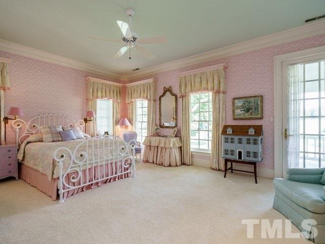 4613 Stormy Gale Road Raleigh, NC 27614 - Photo 18 of 30 a spacious bedroom with a bed a dresser and large windows