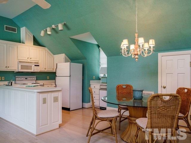 4613 Stormy Gale Road Raleigh, NC 27614 - Photo 22 of 30 a dining room with furniture and chandelier