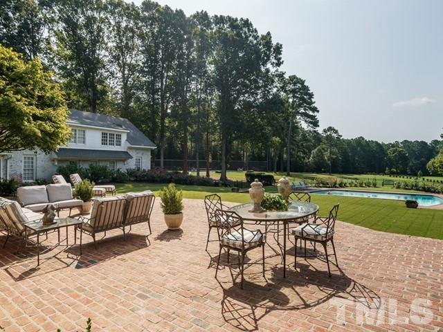 4613 Stormy Gale Road Raleigh, NC 27614 - Photo 24 of 30 a patio with couches and a table and chairs with garden view