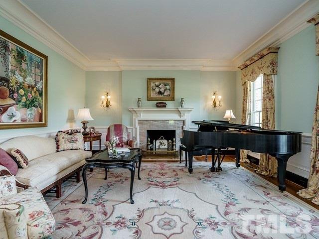 4613 Stormy Gale Road Raleigh, NC 27614 - Photo 6 of 30 a living room with furniture and a fireplace