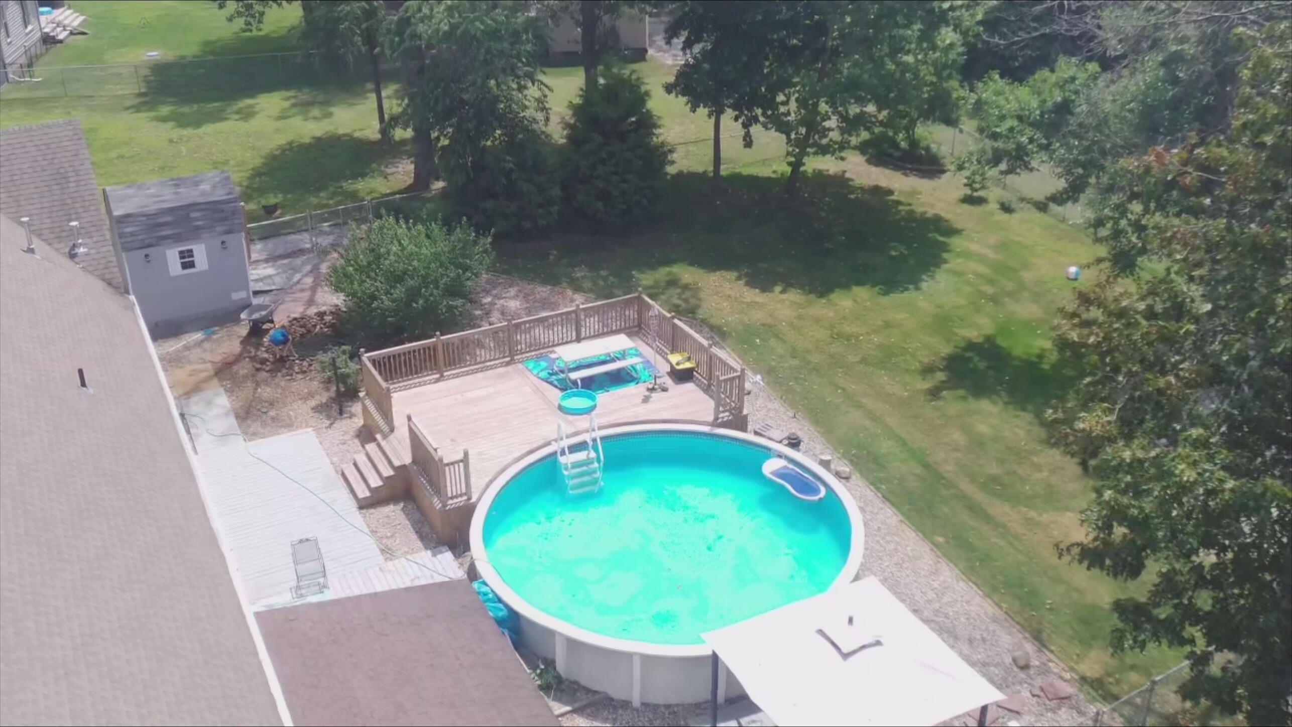 9754 North Charter Road Demotte, IN 46310 - Photo 4 of 60 an aerial view of a swimming pool with outdoor seating and yard