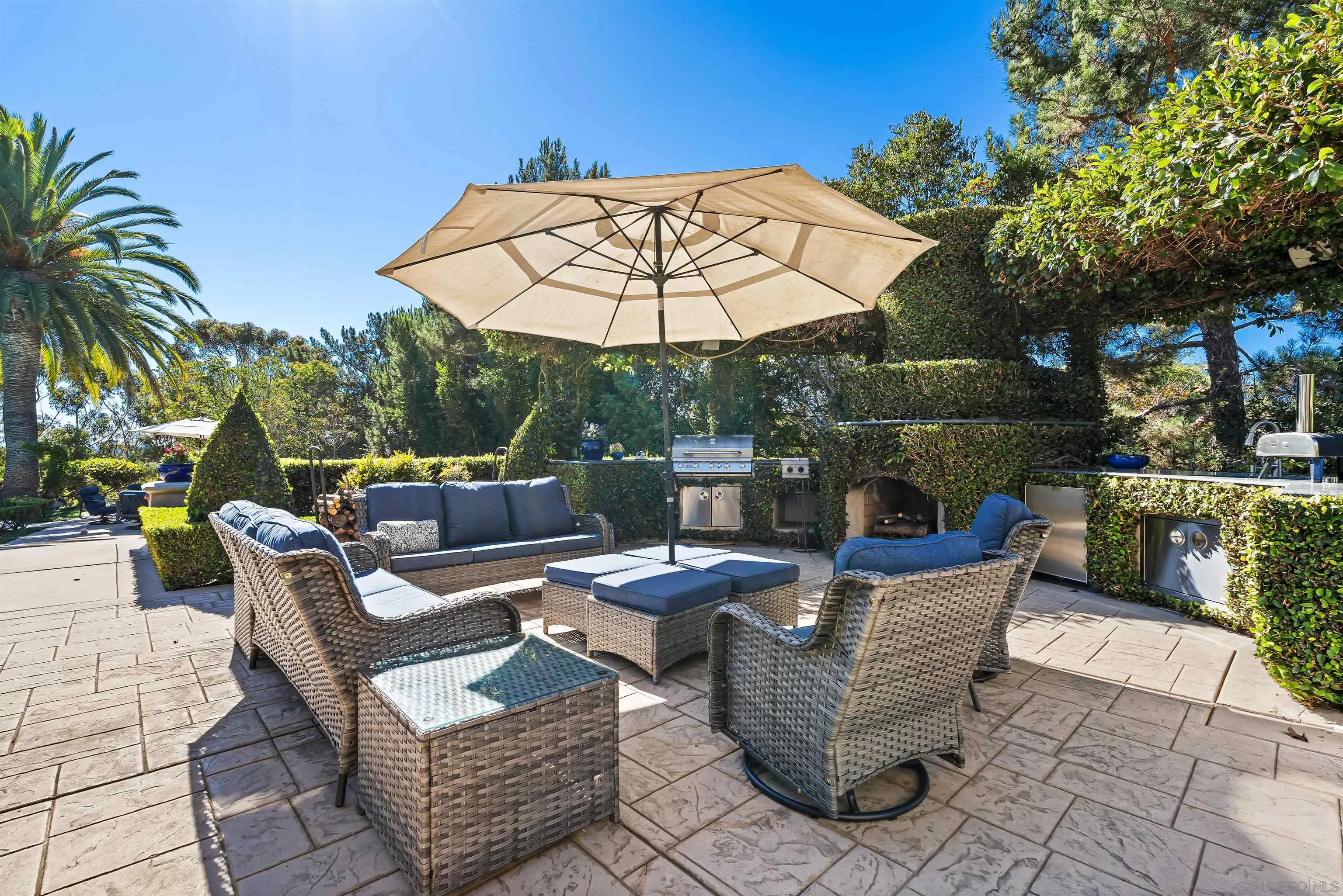 301 Cantle Lane Encinitas, CA 92024 - Photo 41 of 75 a view of a patio with couches and table under an umbrella