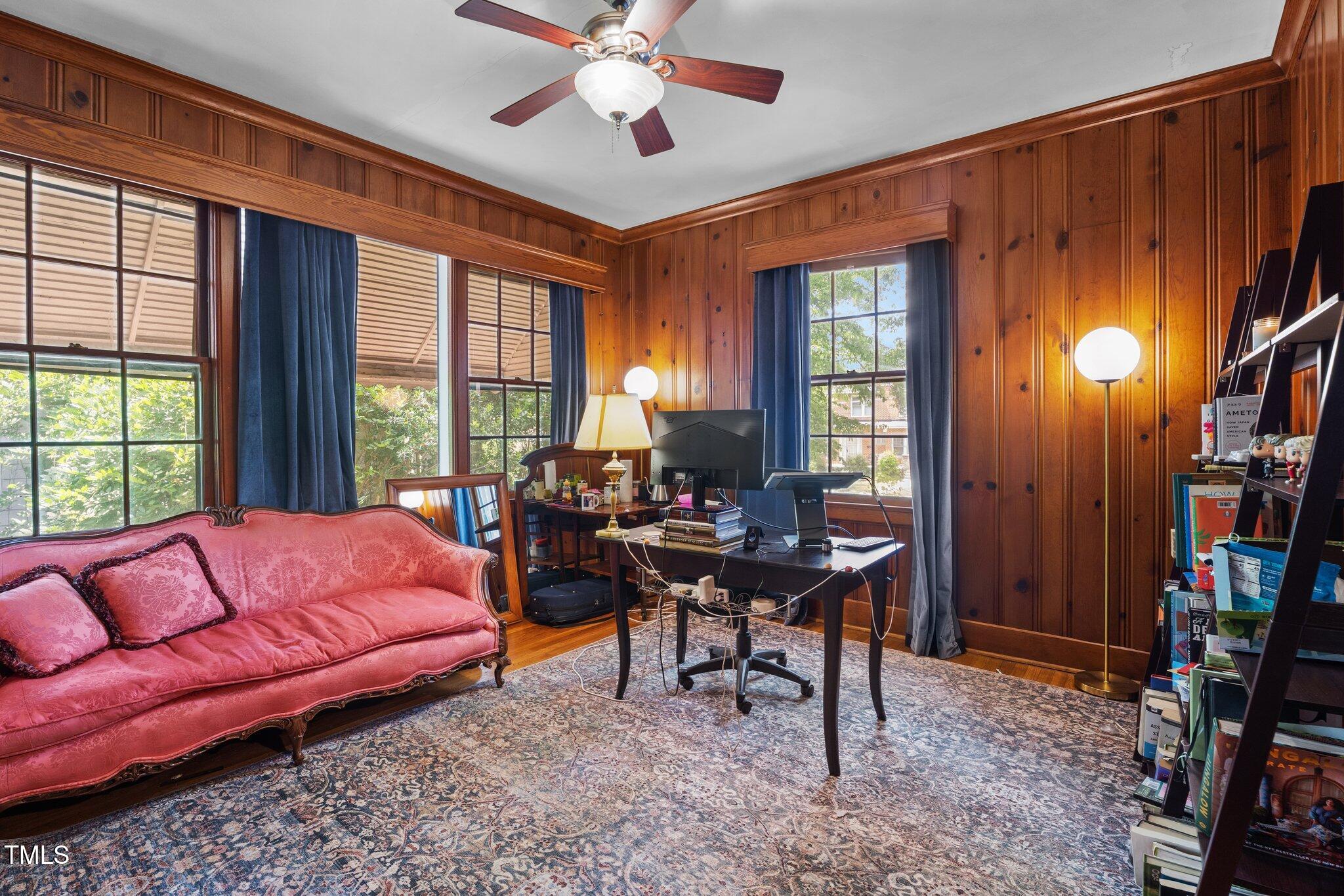 925 South Chestnut Street Henderson, NC 27536 - Photo 11 of 28 a living room with furniture a bookshelf and a window