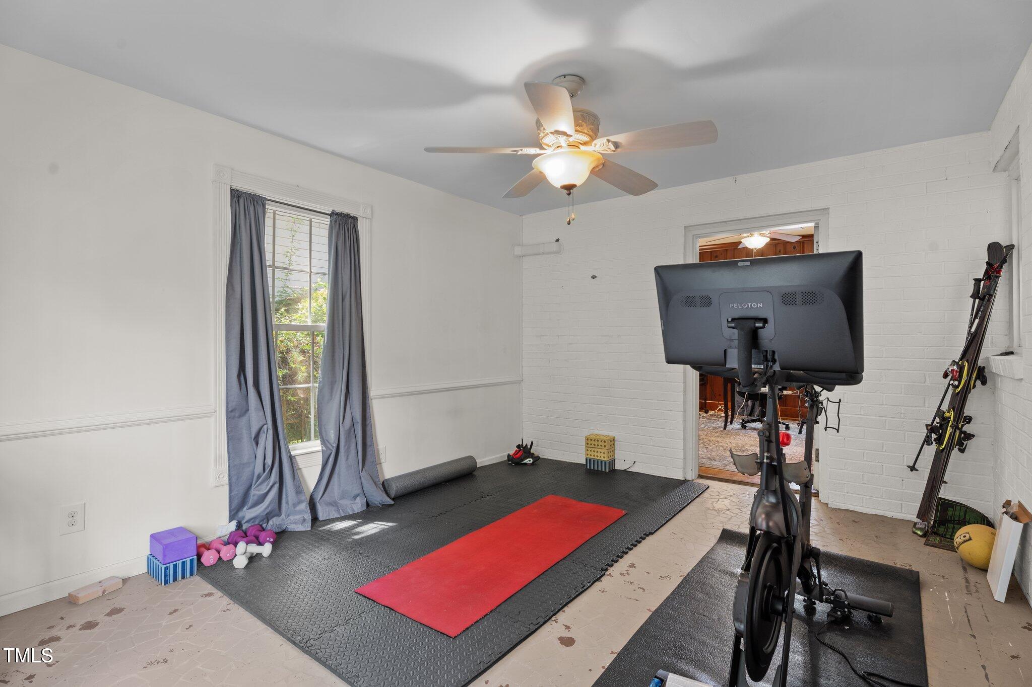 925 South Chestnut Street Henderson, NC 27536 - Photo 12 of 28 a room with gym equipment and a window