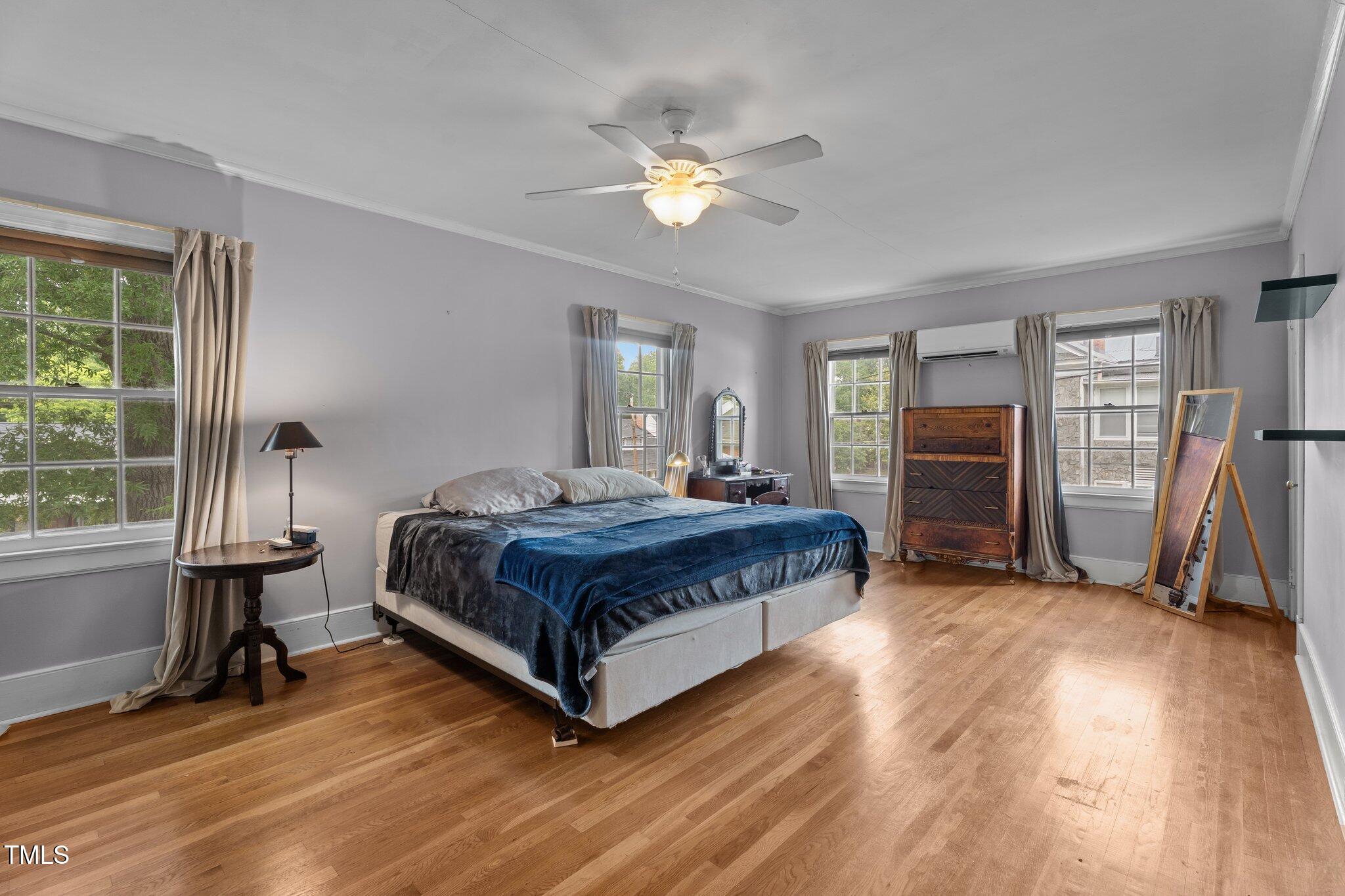 925 South Chestnut Street Henderson, NC 27536 - Photo 14 of 28 a bedroom with a bed and a chandelier