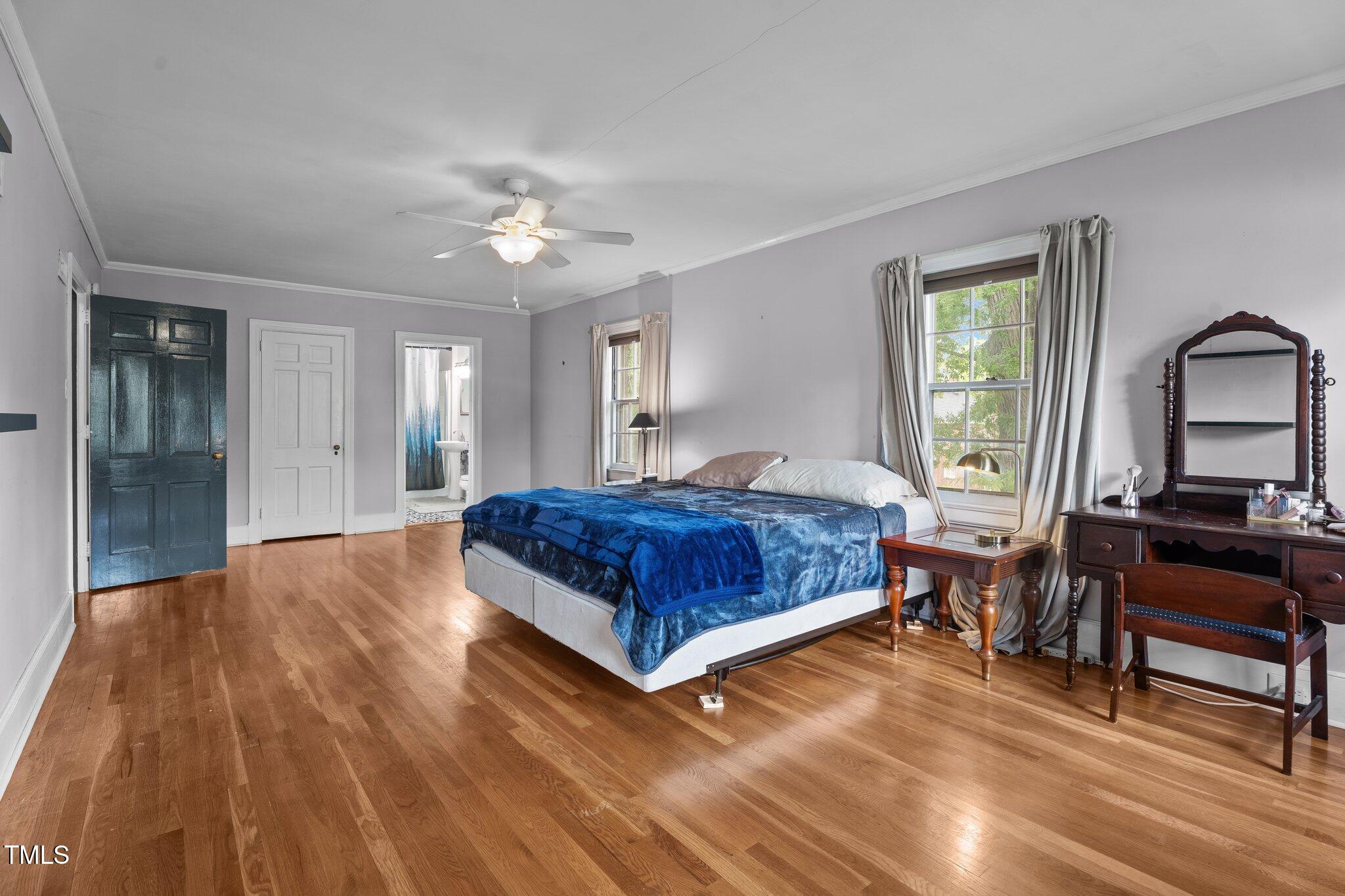 925 South Chestnut Street Henderson, NC 27536 - Photo 16 of 28 a bedroom with a bed and a chandelier