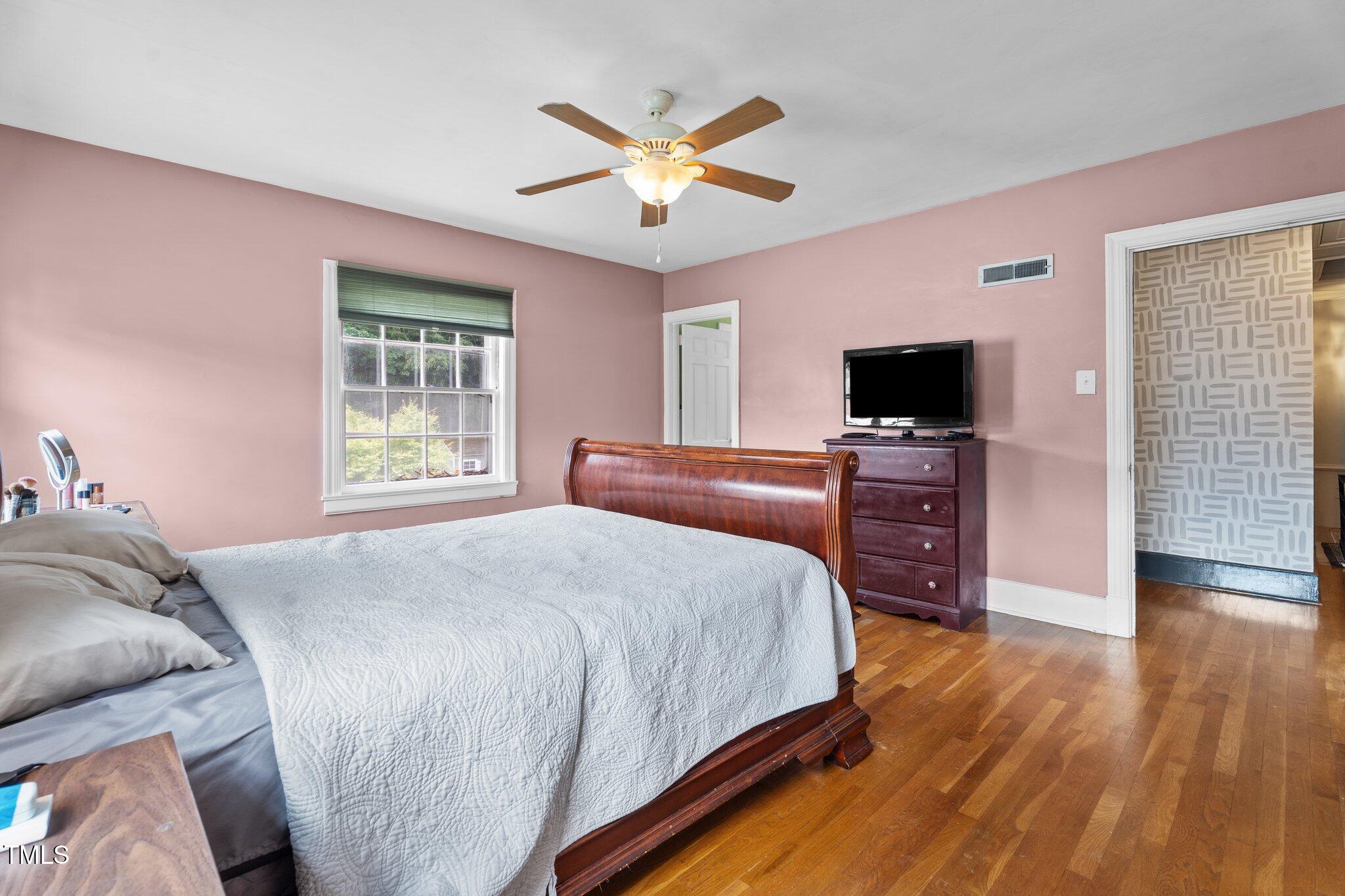 925 South Chestnut Street Henderson, NC 27536 - Photo 18 of 28 a bedroom with a bed and a flat screen tv