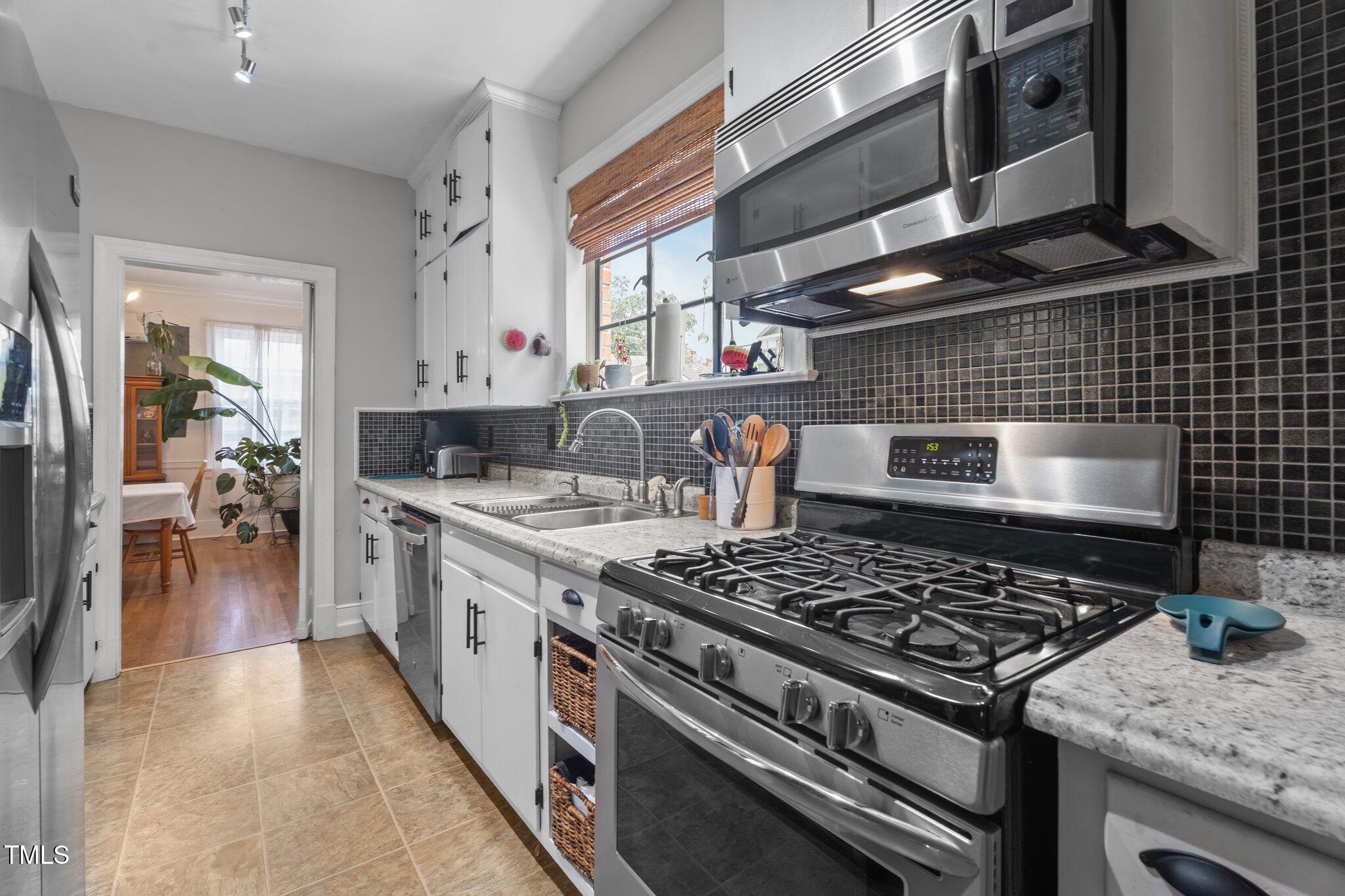 925 South Chestnut Street Henderson, NC 27536 - Photo 6 of 28 a kitchen with a stove and a sink