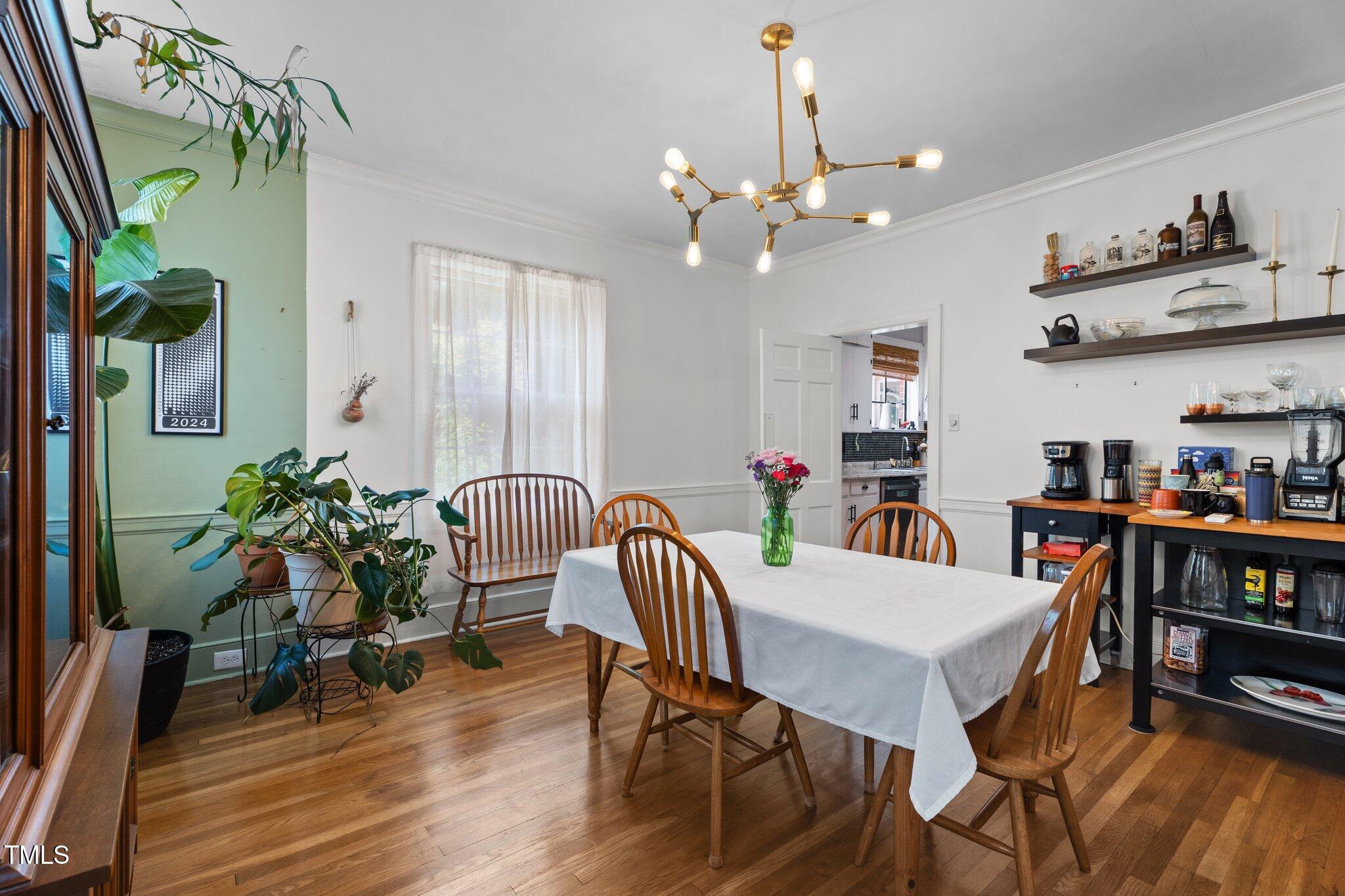 925 South Chestnut Street Henderson, NC 27536 - Photo 8 of 28 a view of a dining room with furniture and wooden floor