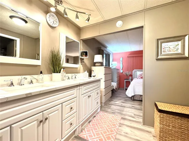 a spacious bathroom with a double vanity sink and a mirror