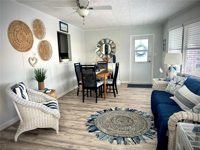 a living room with furniture a table and window