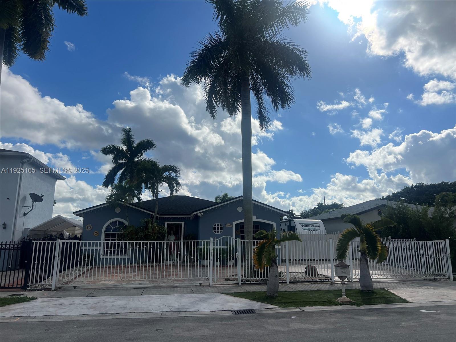 12446 Southwest 198th Street Miami, FL 33177 - Photo 1 of 56 a view of a house with a yard
