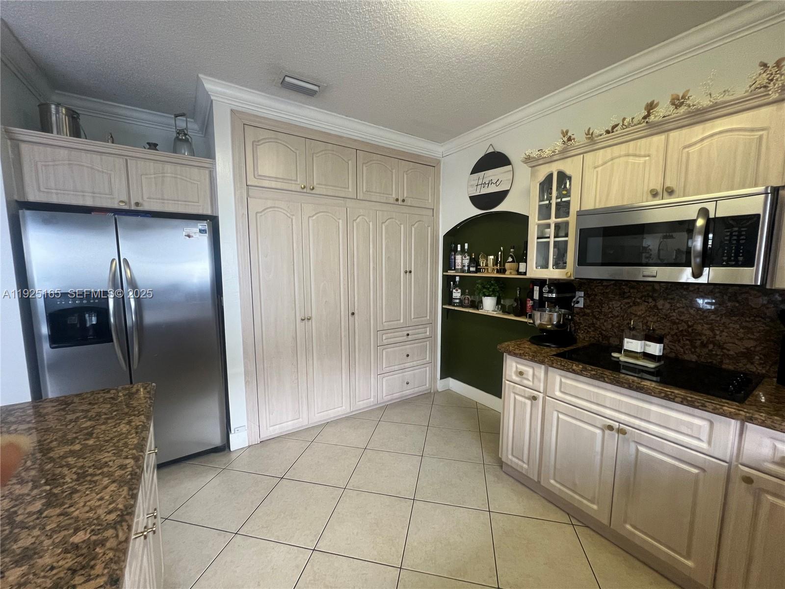 12446 Southwest 198th Street Miami, FL 33177 - Photo 11 of 56 a kitchen with stainless steel appliances granite countertop a refrigerator and a stove top oven