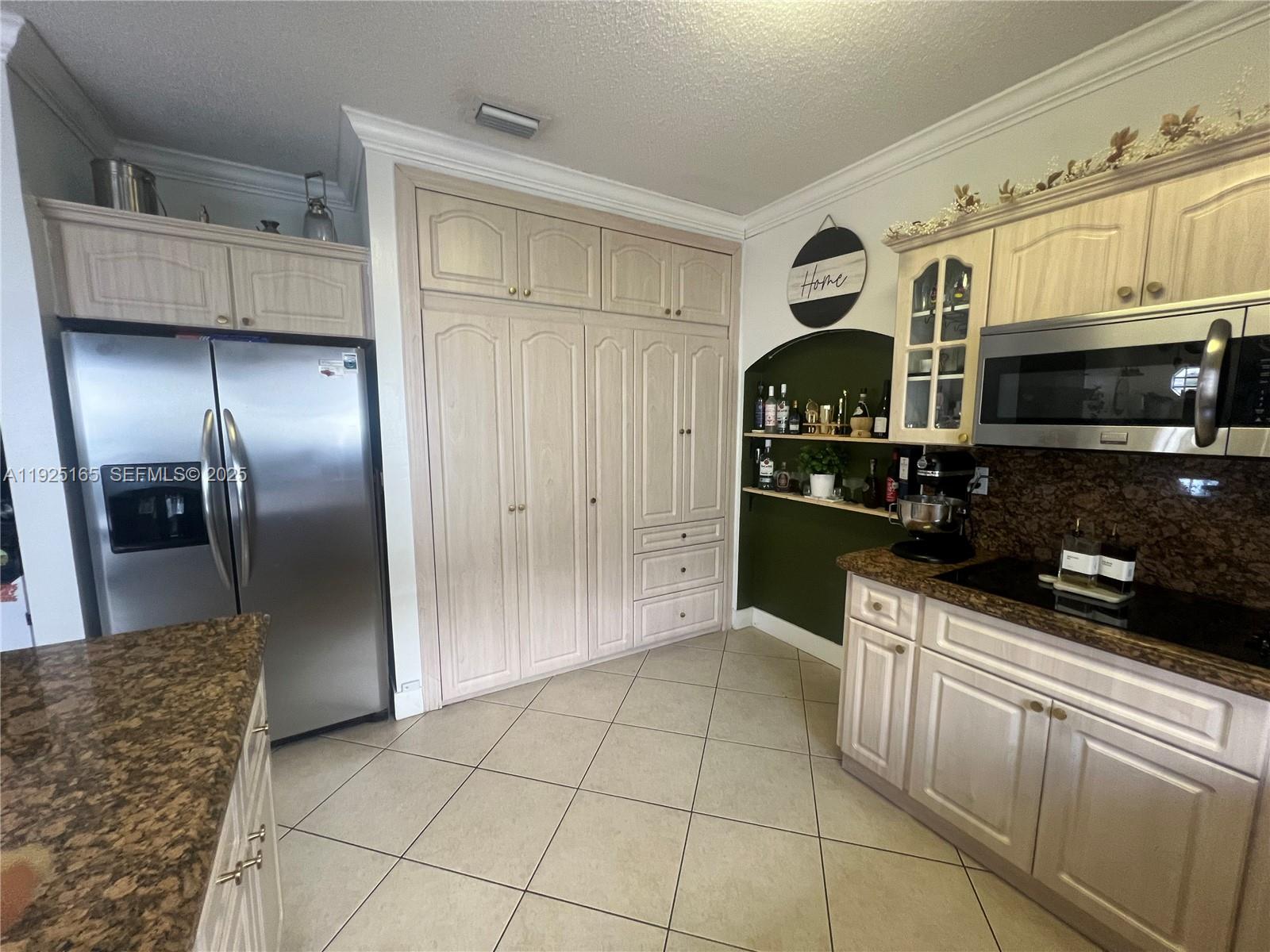 12446 Southwest 198th Street Miami, FL 33177 - Photo 15 of 56 a kitchen with stainless steel appliances granite countertop a refrigerator and a stove top oven