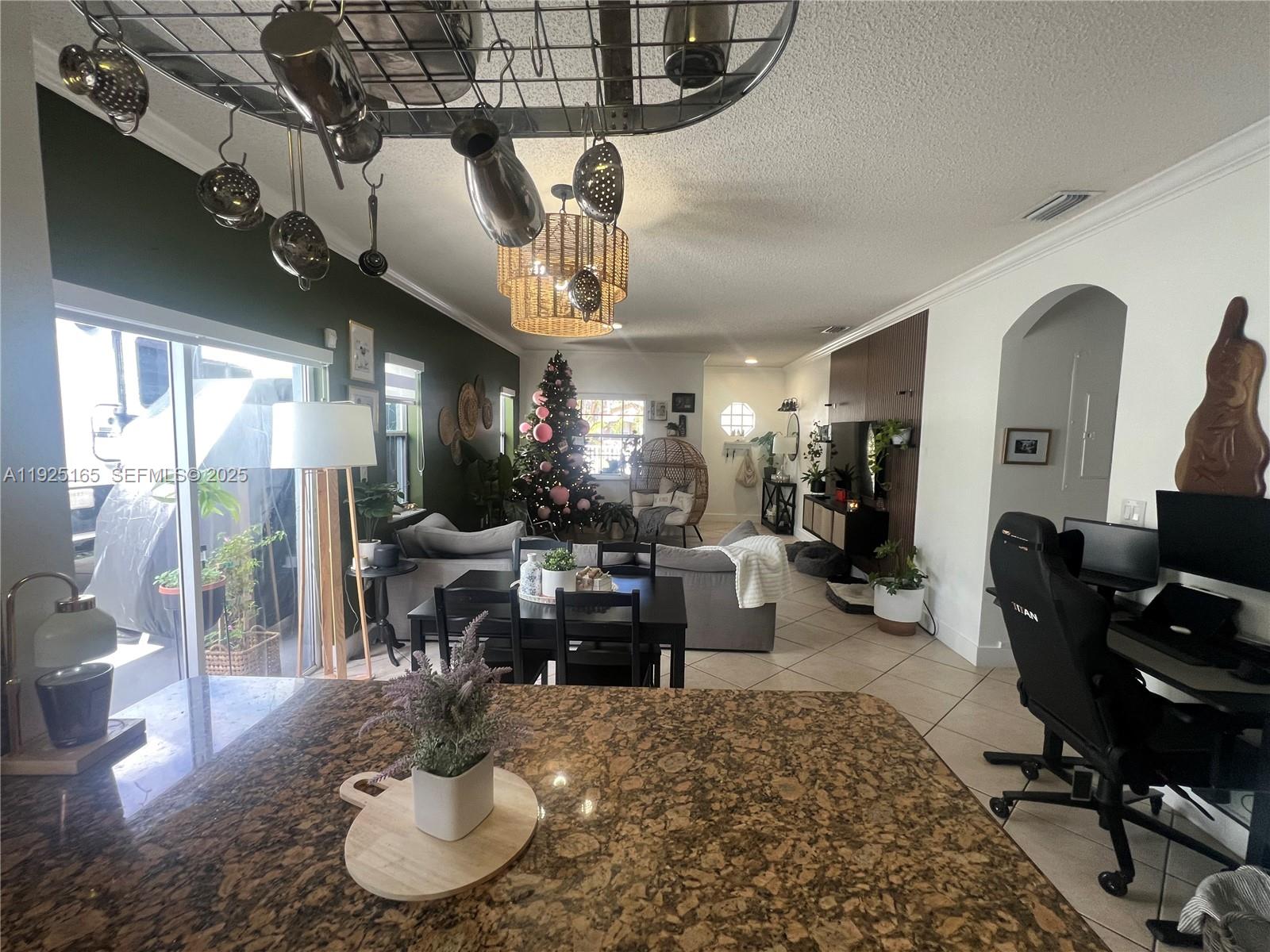 12446 Southwest 198th Street Miami, FL 33177 - Photo 16 of 56 a living room with lots of furniture chandelier and a large window