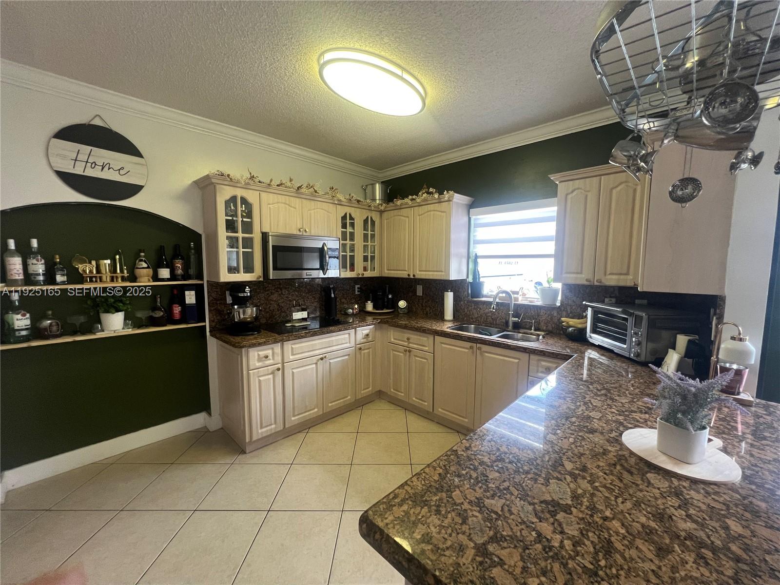 12446 Southwest 198th Street Miami, FL 33177 - Photo 19 of 56 a kitchen with a sink appliances and cabinets