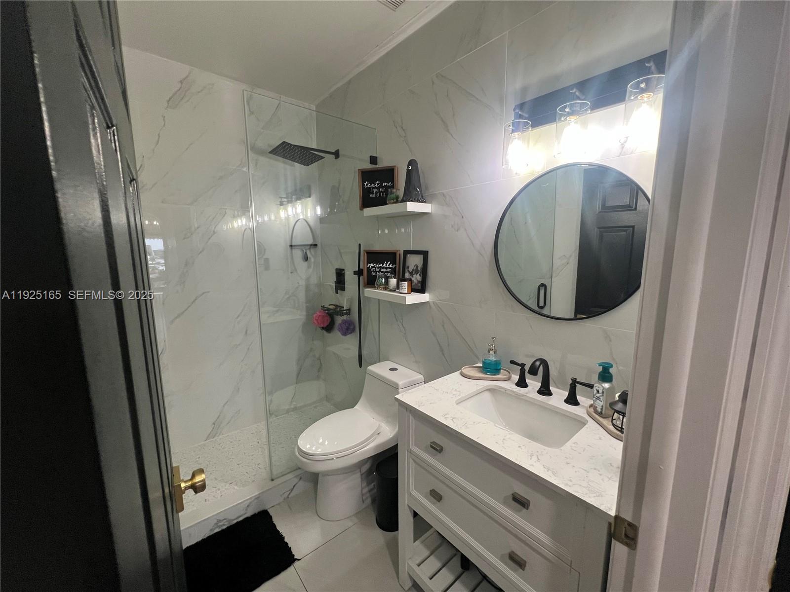 12446 Southwest 198th Street Miami, FL 33177 - Photo 23 of 56 a bathroom with a sink a toilet and shower