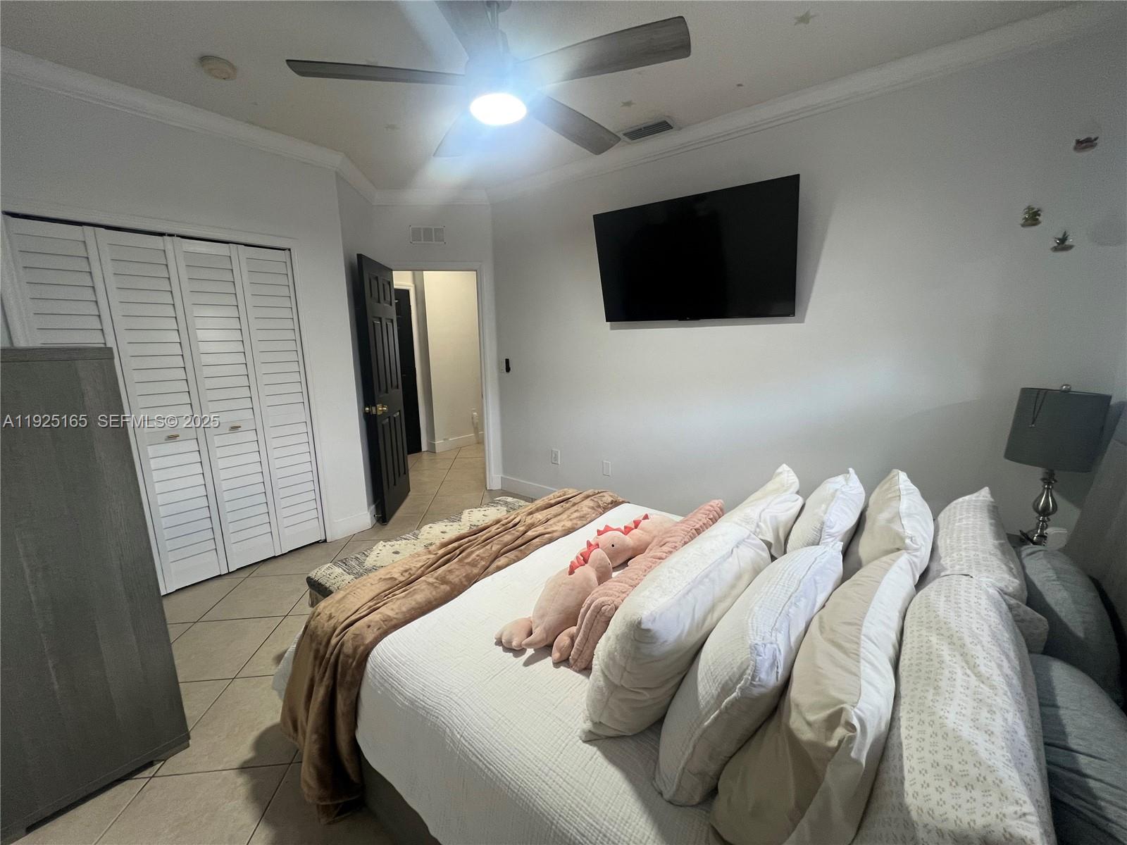 12446 Southwest 198th Street Miami, FL 33177 - Photo 25 of 56 a bedroom with a bed tv and a window