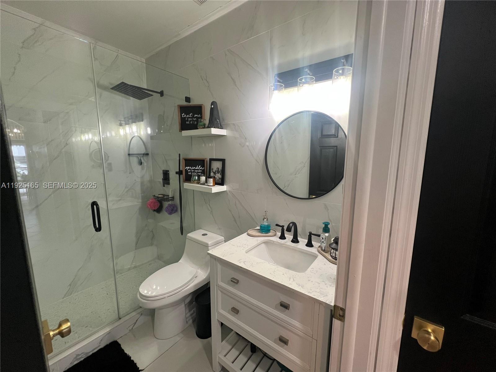 12446 Southwest 198th Street Miami, FL 33177 - Photo 30 of 56 a bathroom with a toilet sink vanity granite and shower