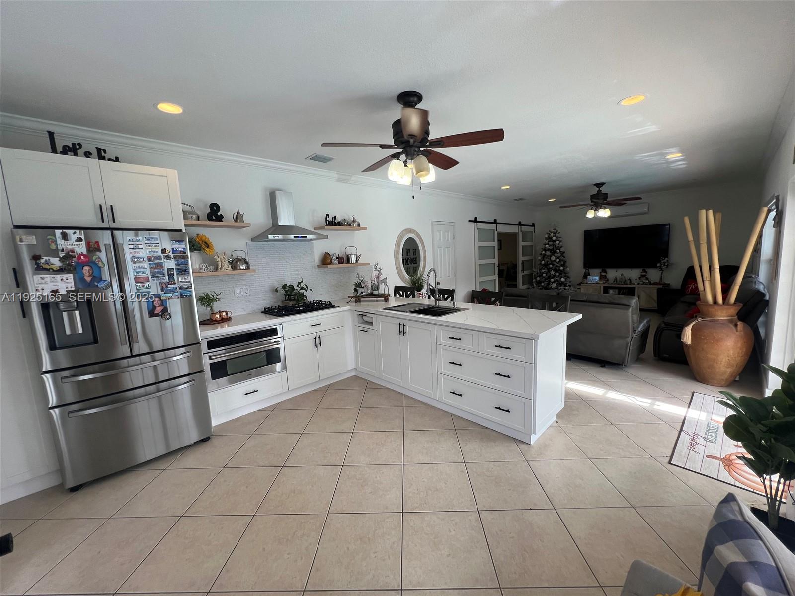 12446 Southwest 198th Street Miami, FL 33177 - Photo 33 of 56 a kitchen with stainless steel appliances a refrigerator sink and cabinets
