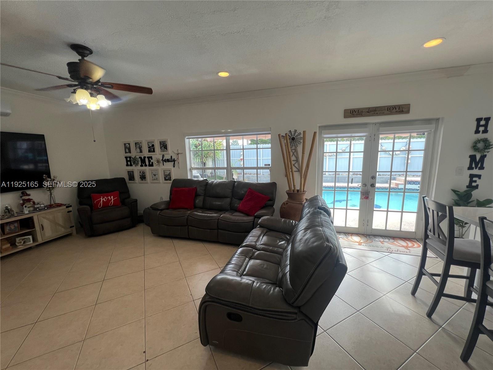 12446 Southwest 198th Street Miami, FL 33177 - Photo 40 of 56 a living room with furniture and a flat screen tv