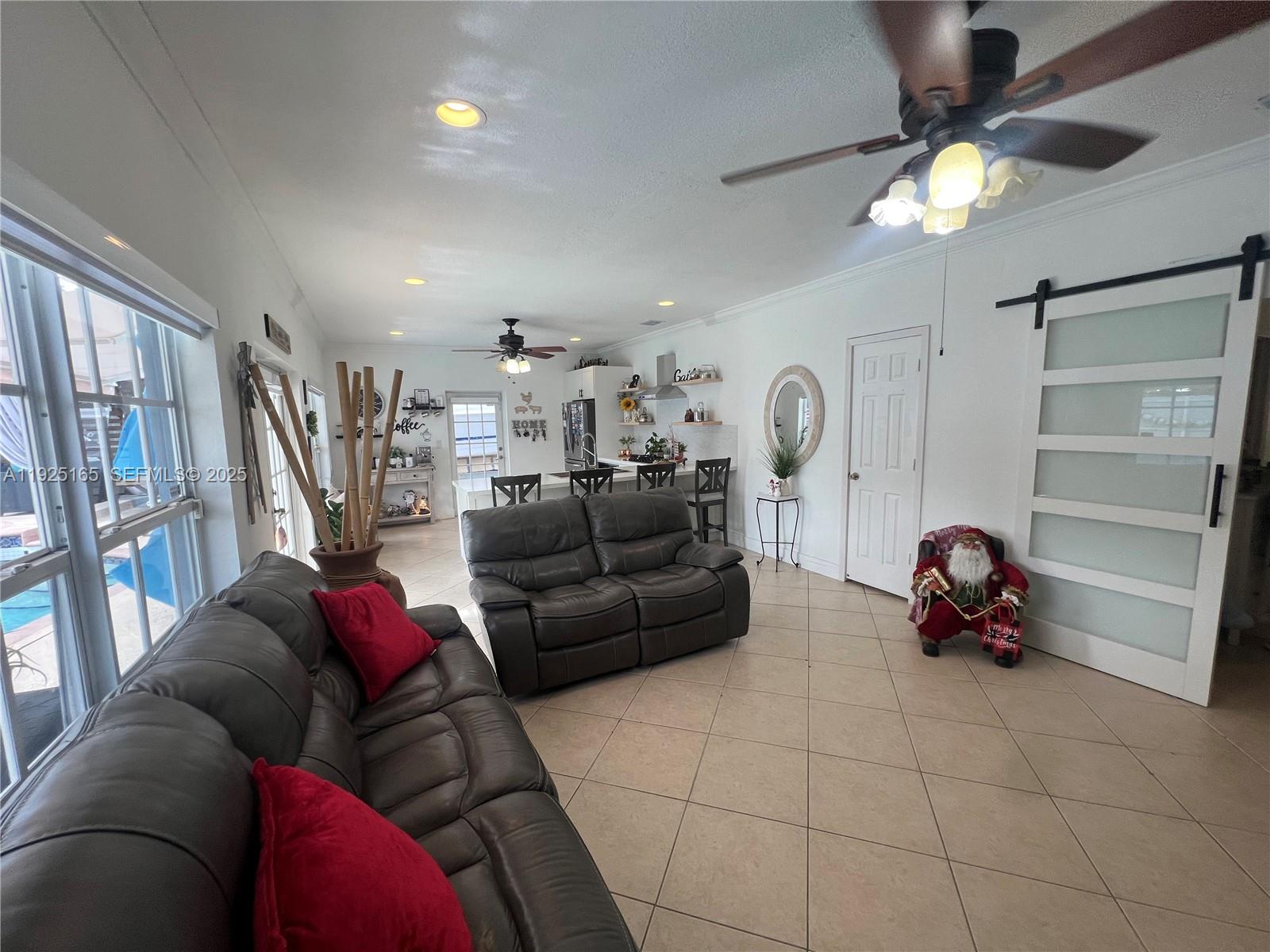 12446 Southwest 198th Street Miami, FL 33177 - Photo 41 of 56 a living room with furniture and a chandelier