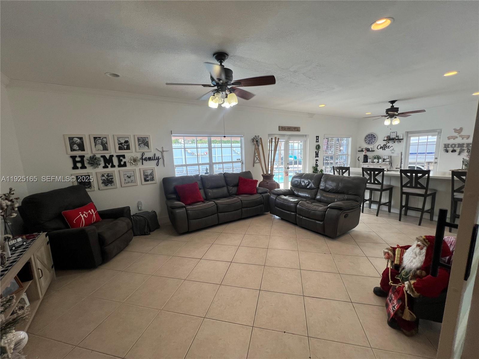 12446 Southwest 198th Street Miami, FL 33177 - Photo 42 of 56 a living room with furniture a air conditioner vent and a window