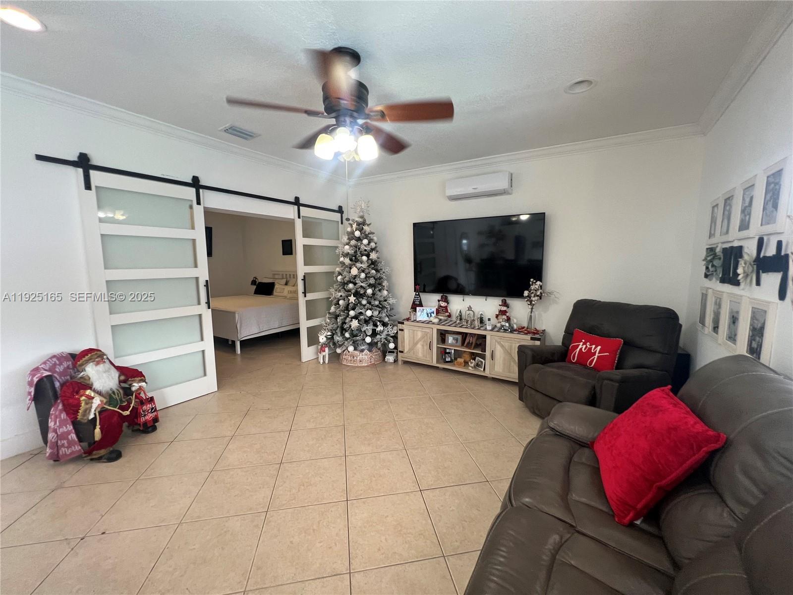 12446 Southwest 198th Street Miami, FL 33177 - Photo 43 of 56 a living room with furniture and a flat screen tv
