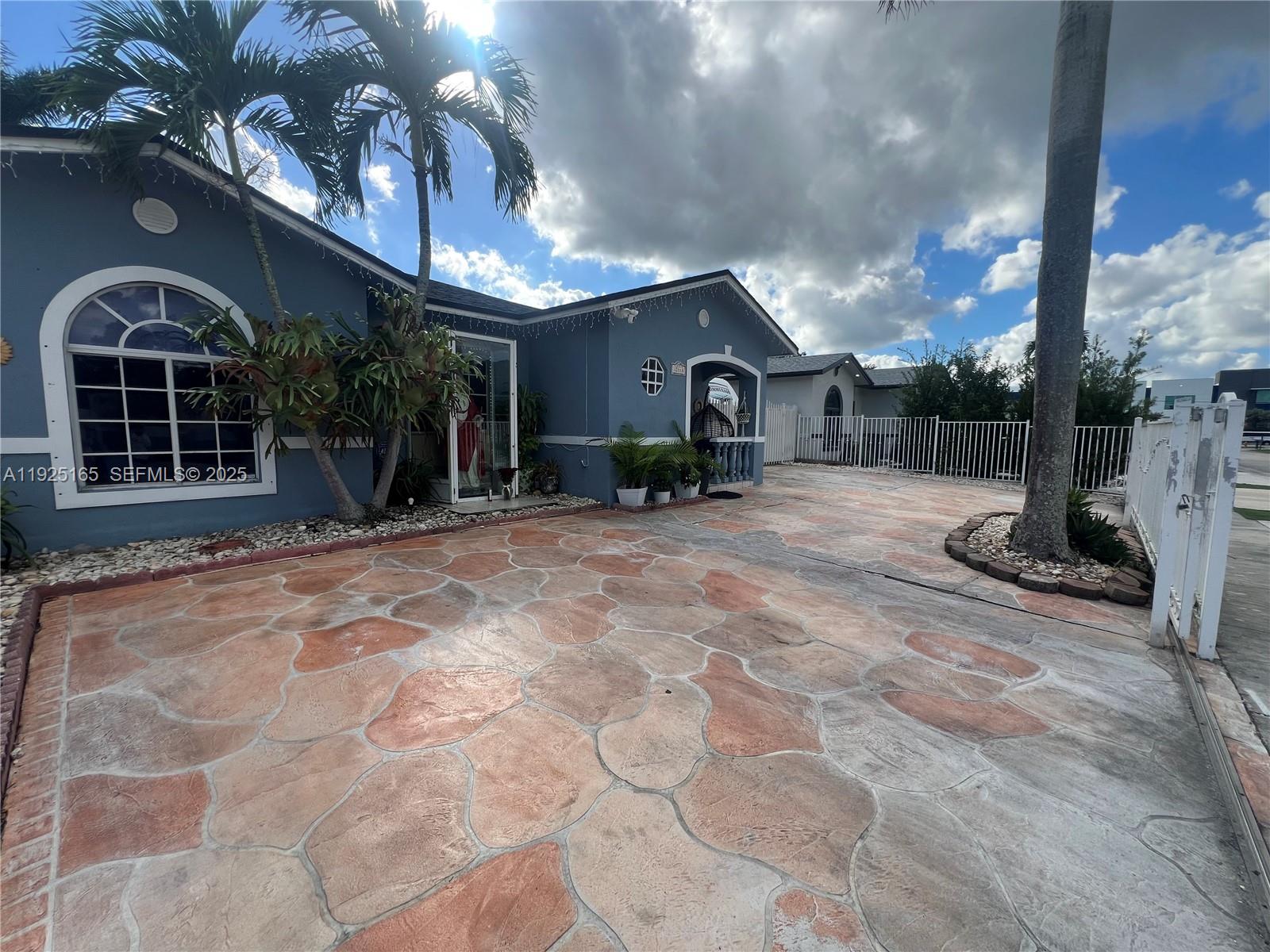 12446 Southwest 198th Street Miami, FL 33177 - Photo 5 of 56 a view of a house with a patio
