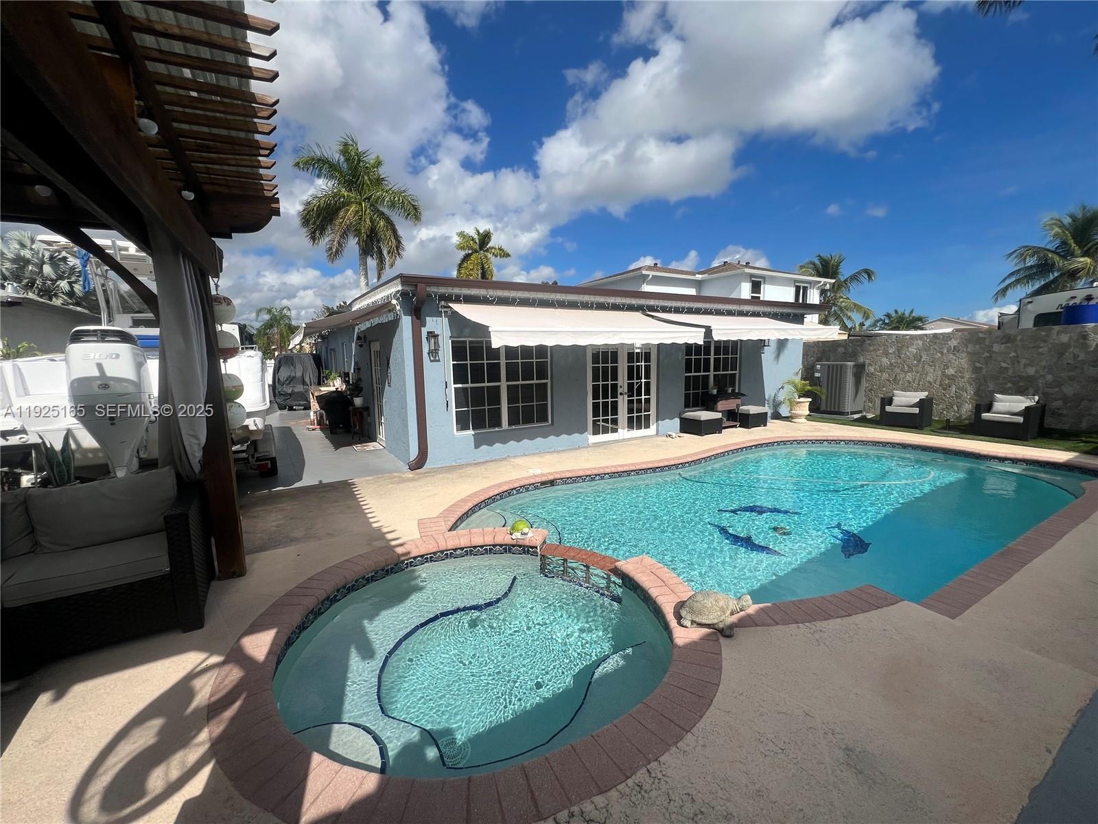 12446 Southwest 198th Street Miami, FL 33177 - Photo 54 of 56 a view of a house with a backyard porch and sitting area