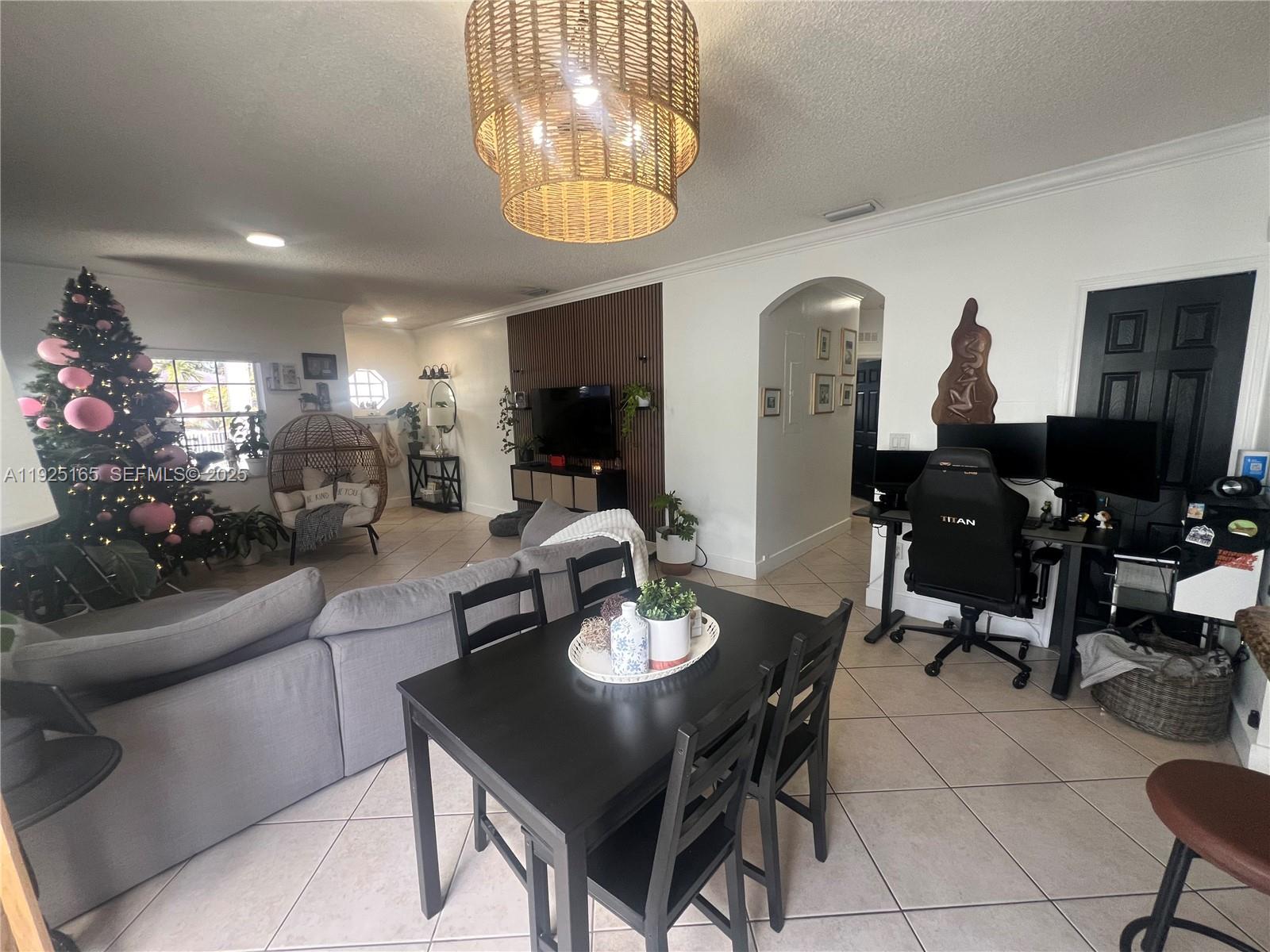 12446 Southwest 198th Street Miami, FL 33177 - Photo 6 of 56 a view of a dining room with furniture and chandelier