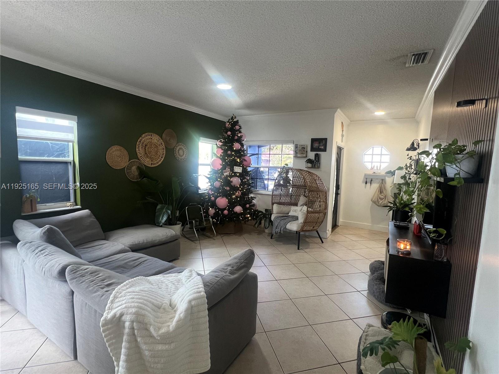 12446 Southwest 198th Street Miami, FL 33177 - Photo 8 of 56 a living room with furniture a dining room with couches bookshelf and a large mirror with wooden floor