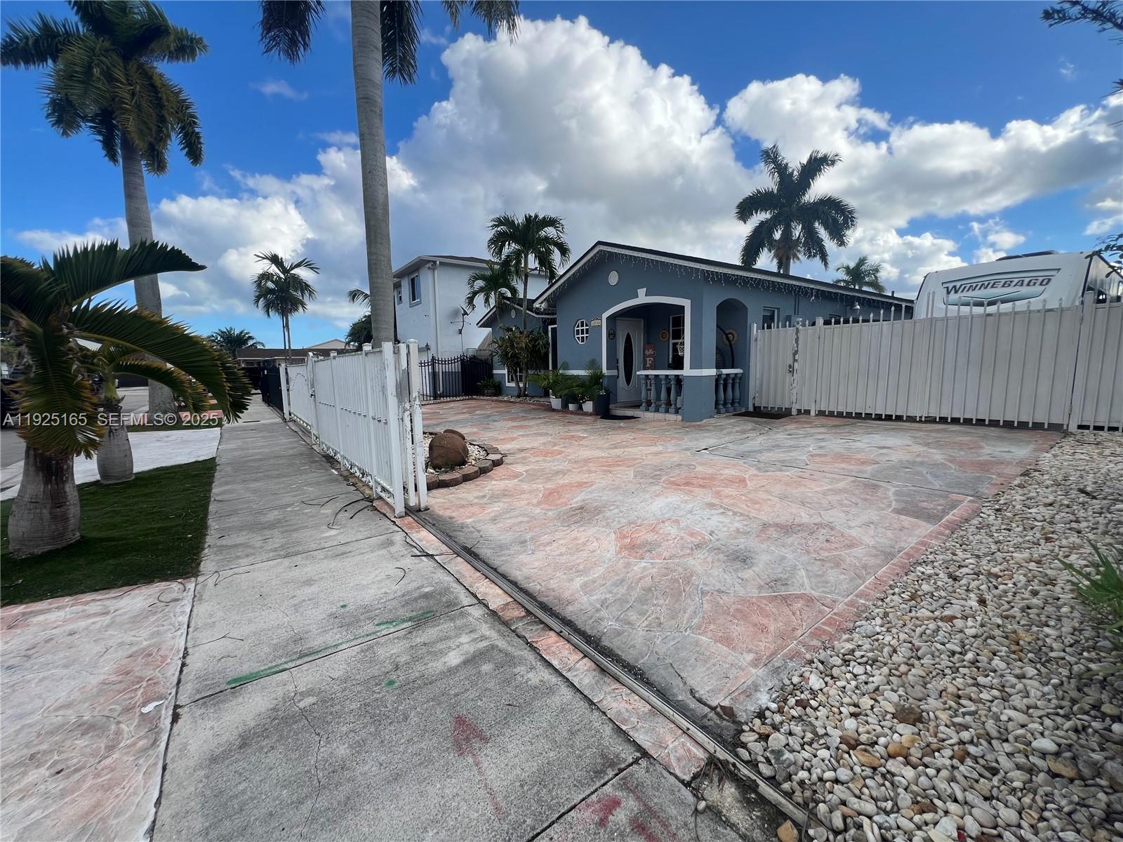 12446 Southwest 198th Street Miami, FL 33177 - Photo 9 of 56 a view of a house with a pathway