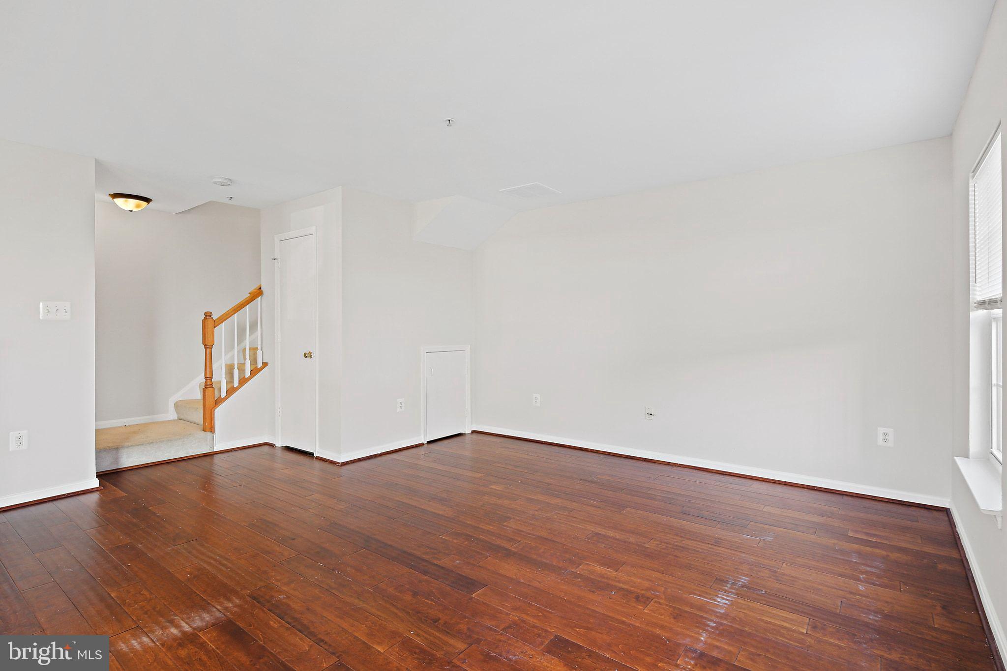 5016 Croydon Terrace Frederick, MD 21703 - Photo 12 of 34 a view of an empty room with wooden floor and a window