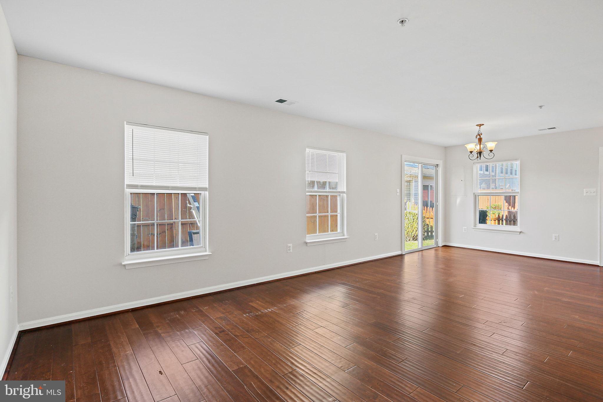5016 Croydon Terrace Frederick, MD 21703 - Photo 13 of 34 an empty room with wooden floor and windows