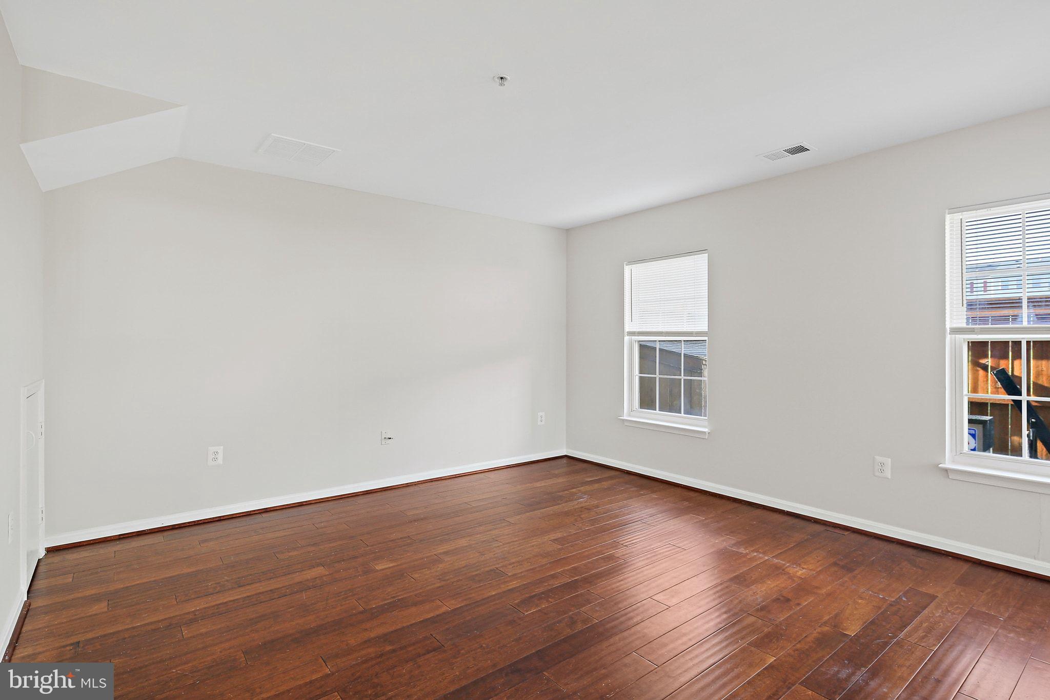 5016 Croydon Terrace Frederick, MD 21703 - Photo 14 of 34 a view of an empty room with wooden floor and a window