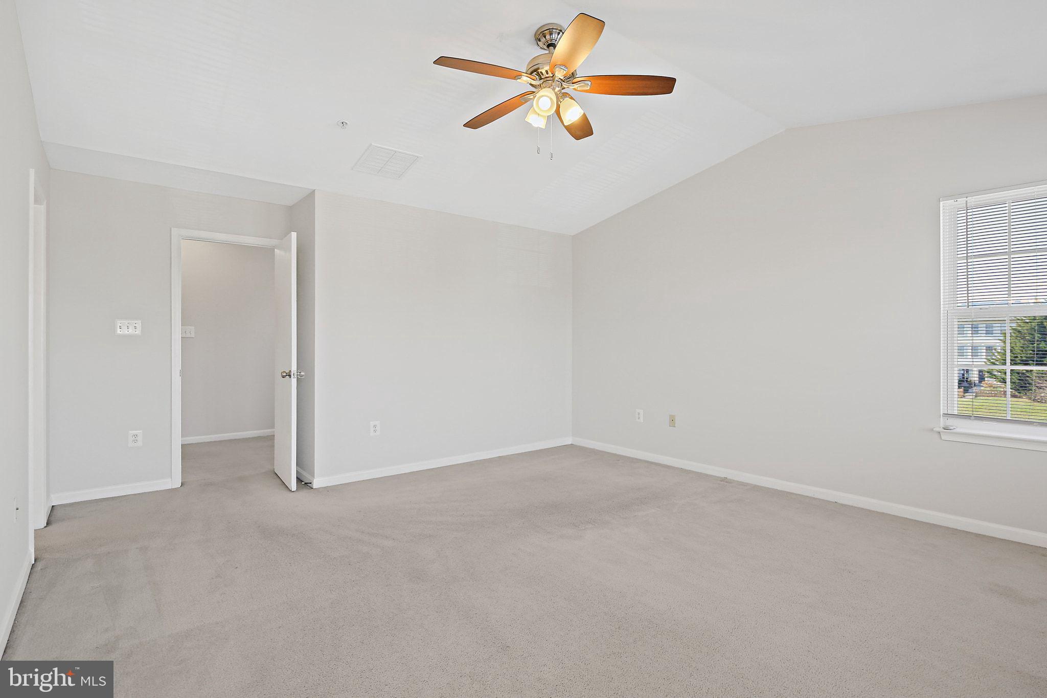 5016 Croydon Terrace Frederick, MD 21703 - Photo 17 of 34 an empty room with windows and fan chandelier fan