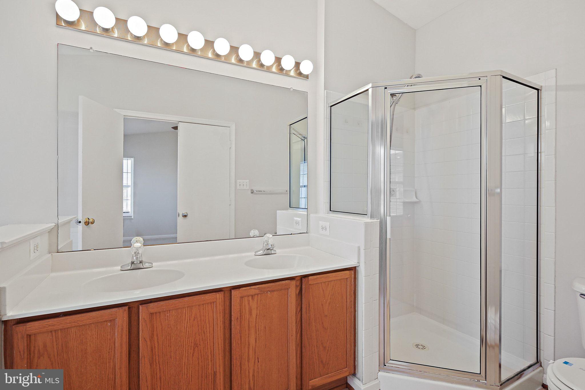 5016 Croydon Terrace Frederick, MD 21703 - Photo 19 of 34 a bathroom with double sink and a mirror