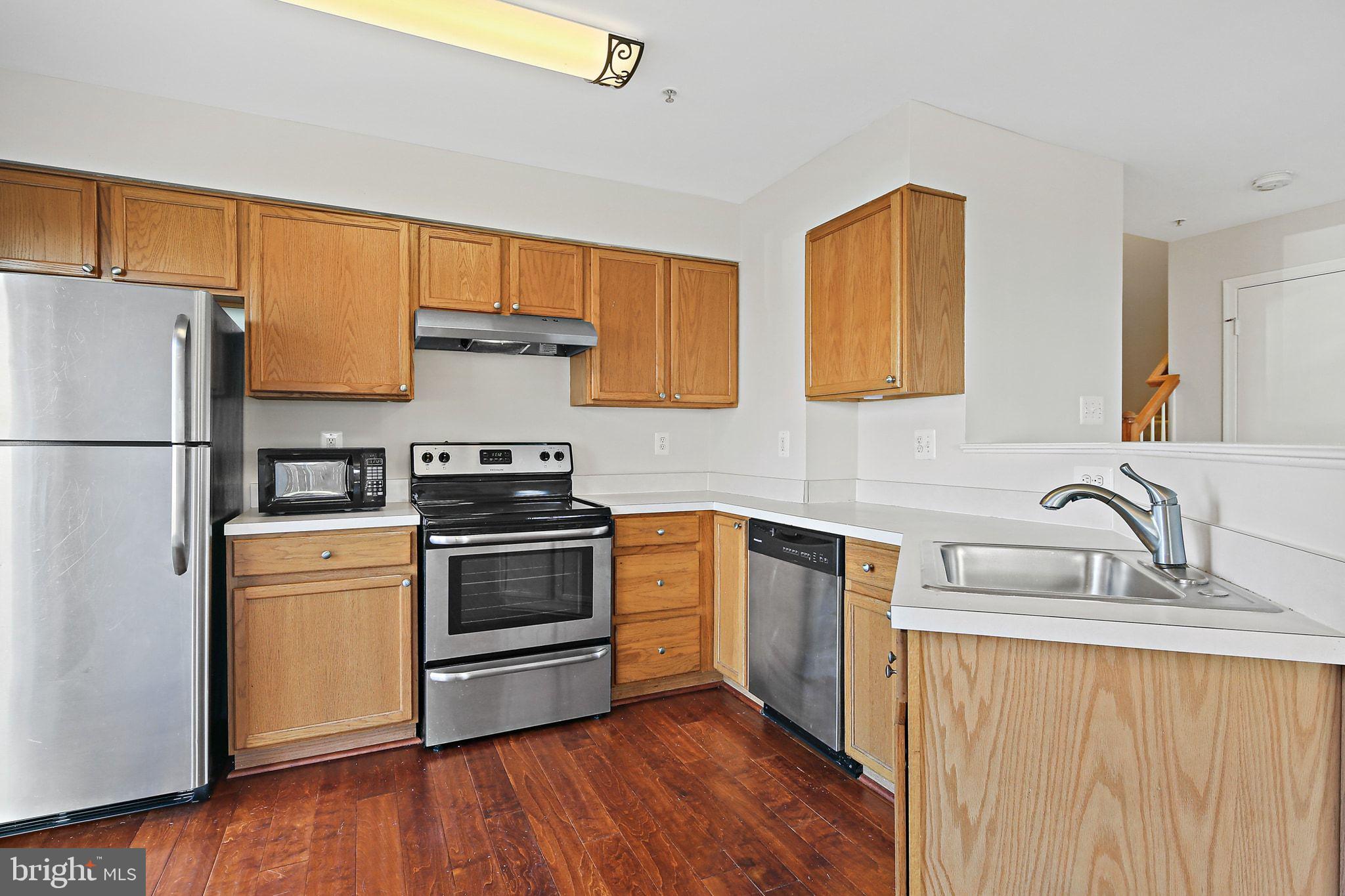 5016 Croydon Terrace Frederick, MD 21703 - Photo 4 of 34 a kitchen with a sink a refrigerator and a stove
