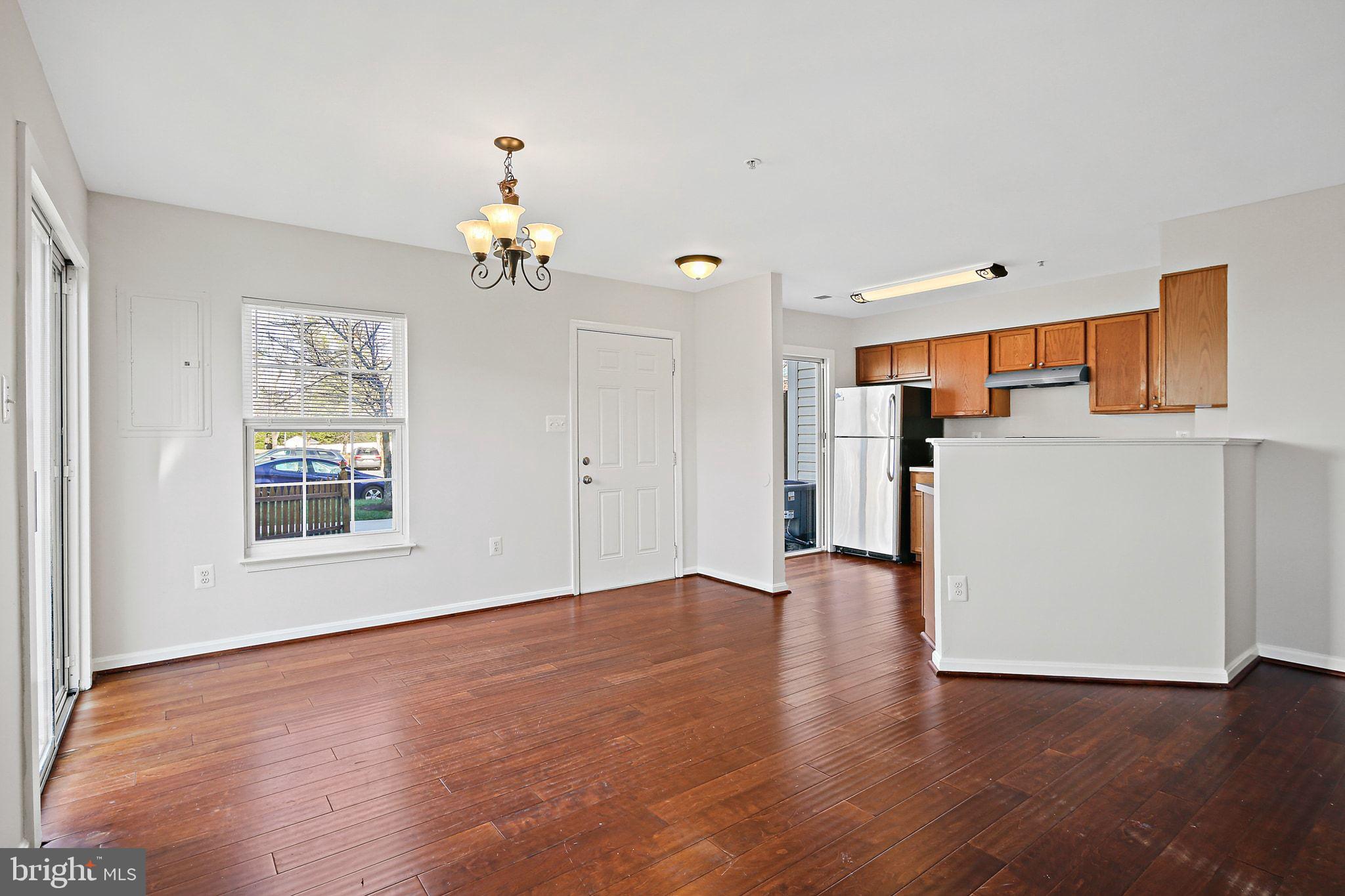 5016 Croydon Terrace Frederick, MD 21703 - Photo 7 of 34 an empty room with wooden floor ceiling fan and windows