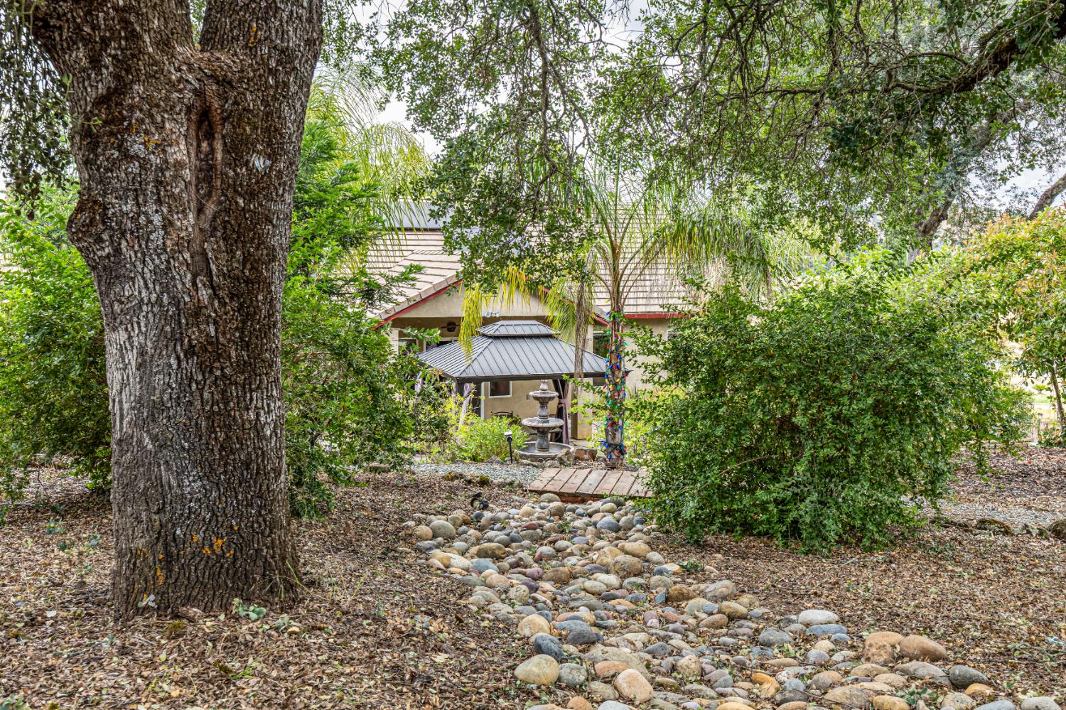 2083 State Rte 26 Valley Springs, CA 95252 - Photo 35 of 59 a yellow house with trees in front of it
