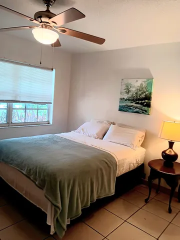 a bathroom with a granite countertop double vanity sink and two mirror